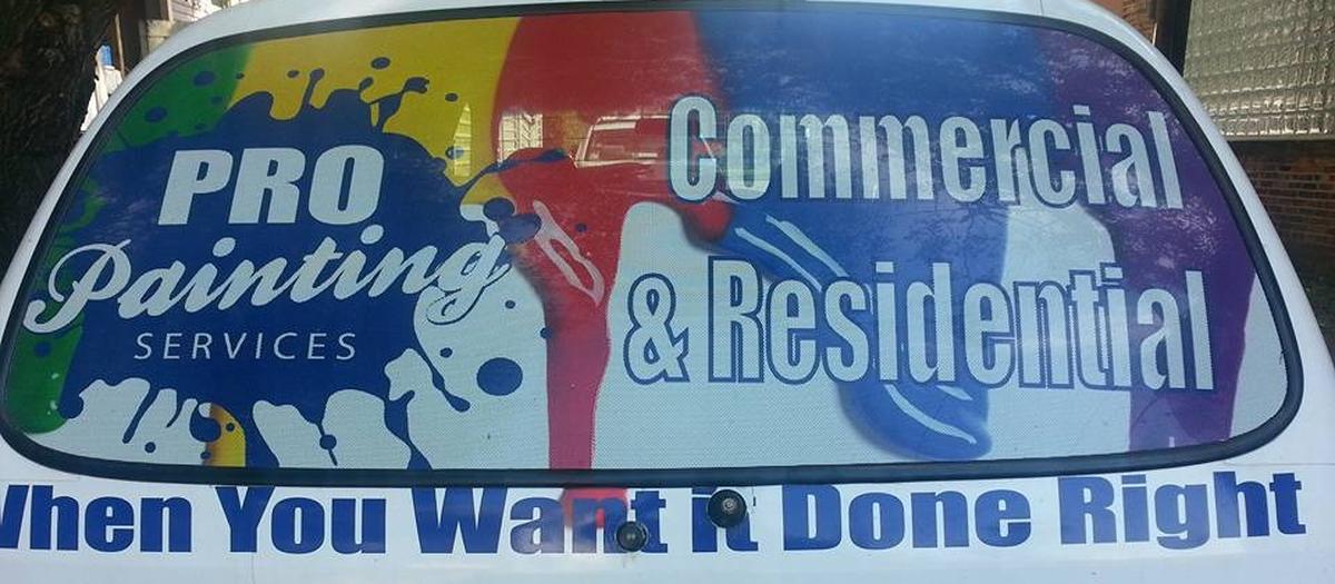 The back window and rear door of a white van with a paint-splash Pro Painting Services logo, the words Commercial and Residential, and a phone number.